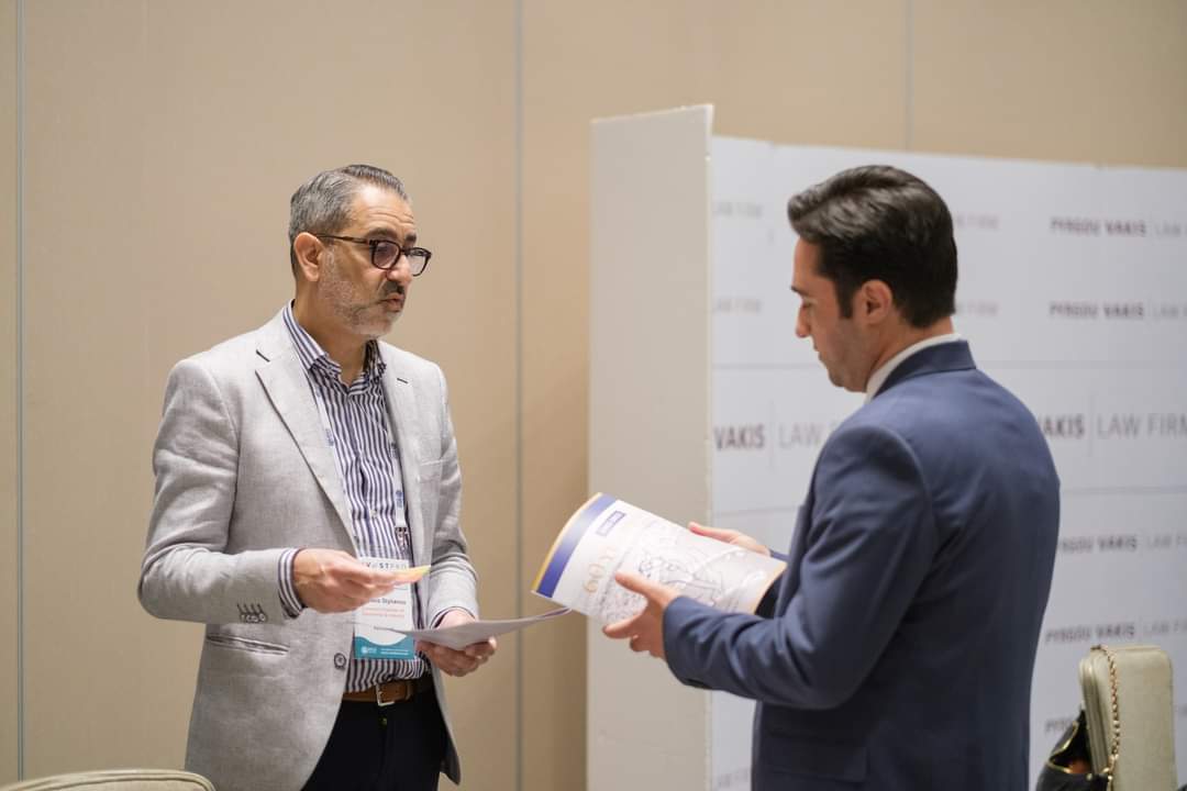 Ehsan Amiri, Director of eyetouch, engaging with an international business professional during InvestPro Cyprus Limassol 2025.